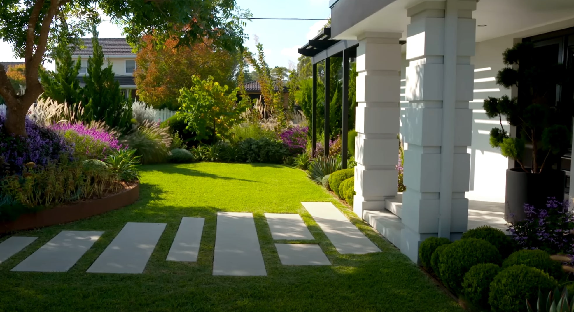 Modern Front Yard Design Modern front yard landscaping with colorful perennial gardens and contemporary paver walkway