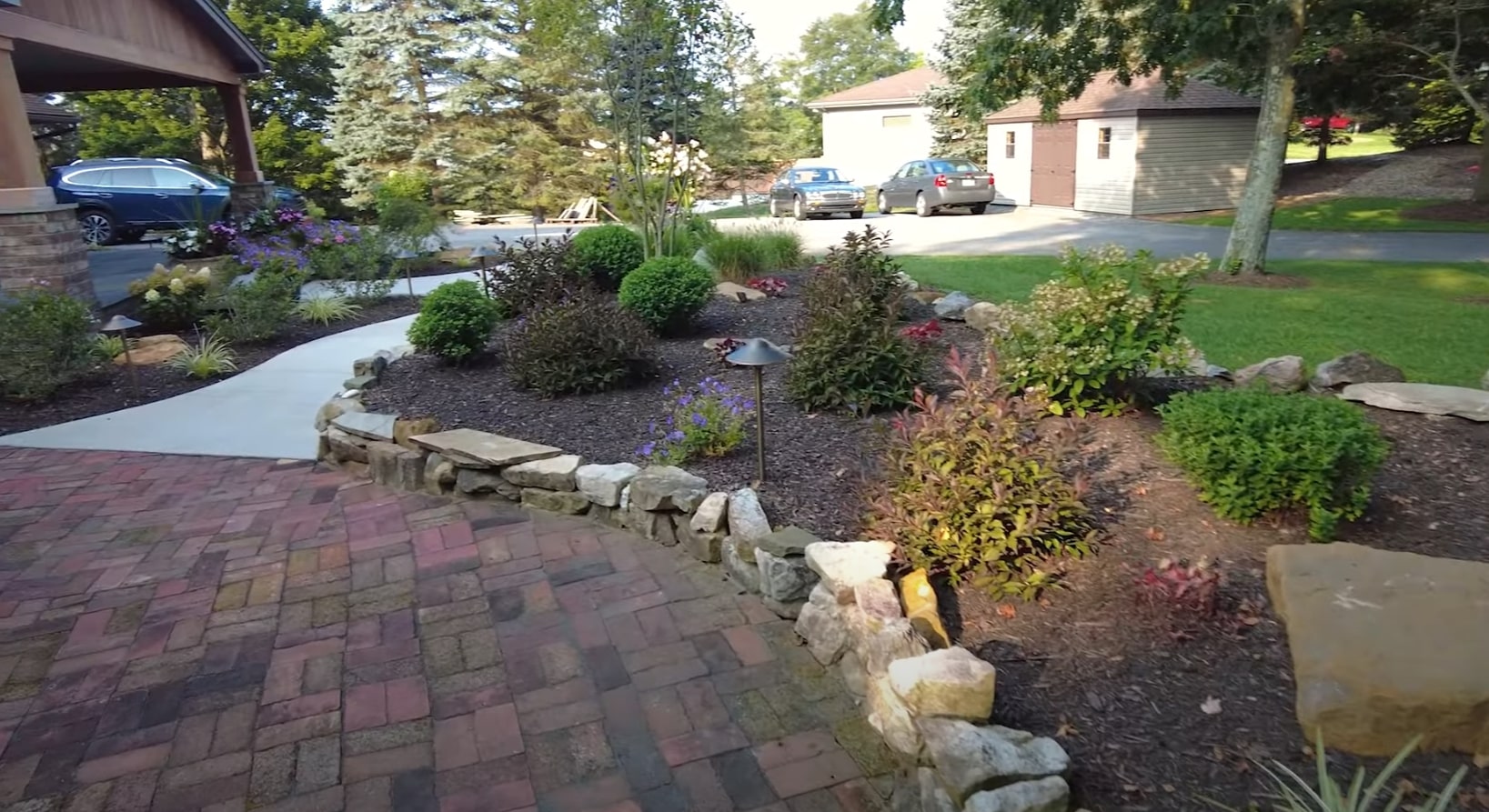 Comprehensive Landscaping Services - Portsmouth Landscaping Elegant front yard landscaping with stone retaining walls, colorful plantings, and professional paver installation