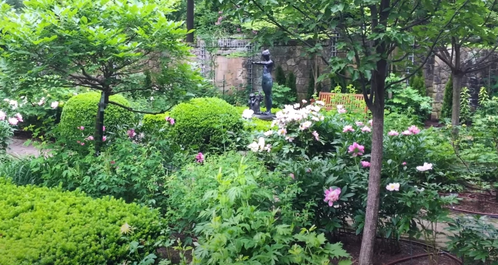 Beautiful custom landscape design with flowering plants and water features