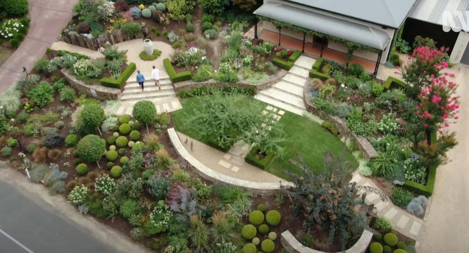 Landscape Design Excellence - Portsmouth Landscaping Aerial view of beautifully landscaped garden with curved lawn areas, diverse plantings, and professional landscape design